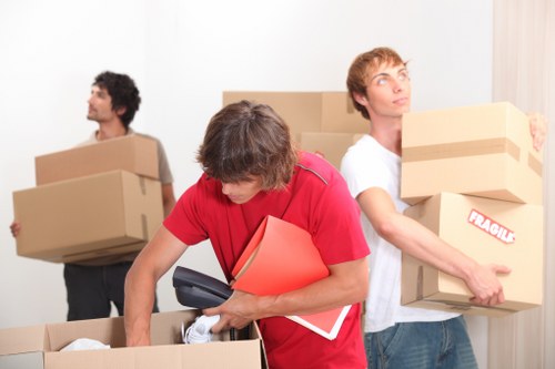 Staff handling packed boxes with care during removal work